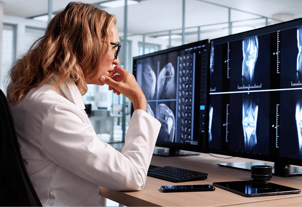 Radiologist reviewing medical imaging with a physician